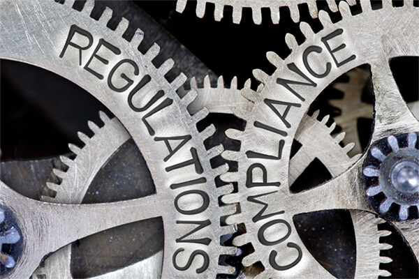 Gears depicting the words Regulation and Compliance